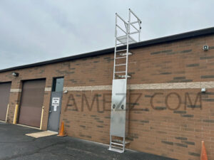 Photo of A-Mezz MRL modular aluminum roof ladder with gutter crossover platform and lockable removable rung cover