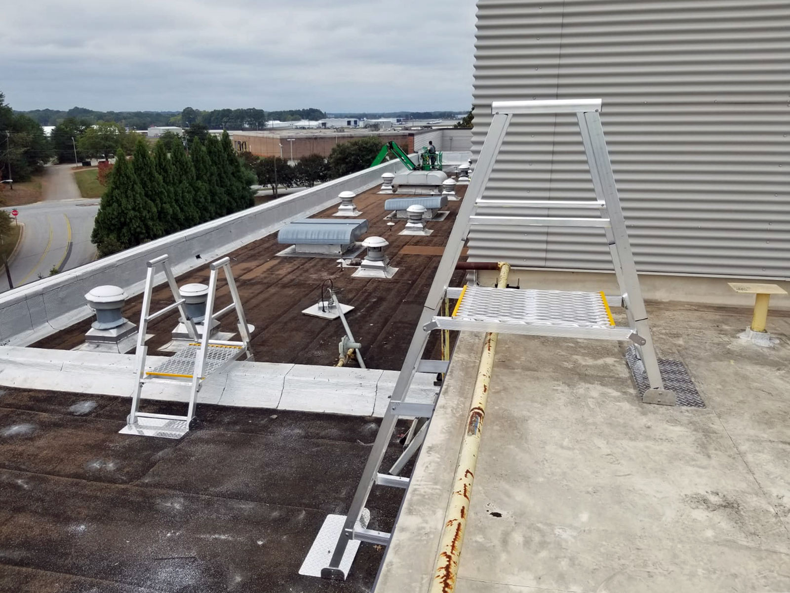 Angled aluminum fixed modular ladders with crossovers for parapet and roof obstructions